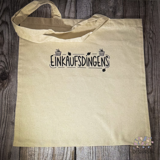 Naturfarbener Jutebeutel mit schwarzem Aufdruck „Einkaufsdingens" von Designbär